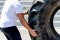 Man moves a huge wheel of industrial machines