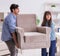 Man moving armchair in the living room