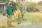 Man mowing cutting grass in his garden yard