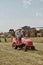 Man mowing his lawn using riding lawnmower