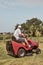 Man mowing his lawn using riding lawnmower