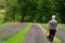 A man mows the grass with an electric lawnmower. Lithium Ion battery powered Electric Lawn mower.