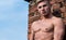 Man muscular athlete lean on wall relaxed. Strong chest muscles emphasize masculinity sexuality. Man muscular naked