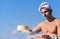 Man muscular baker or cook sifts flour through sieve. Baker working with flour and sieve, kneading dough. Hands of chef