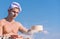 Man muscular baker or cook sifts flour through sieve. Baker working with flour and sieve, kneading dough. Hands of chef