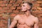 Man muscular chest naked torso stand brick wall background. Attractive and confident. torso sportsman. Man muscular