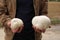 A man, a mushroom picker, holding large mushrooms in his hands, Lycoperdaceae, close-up