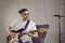 Man musician play guitar sing on microphone in studio