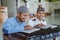 Man muslim learing to reading quran together during ramadan