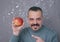 Man with mustaches showing Valentine apple