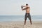 Man with a naked body doing kettlebell exercise