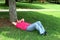 Man Napping In Shade Under a Tree