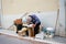 A man naps on wooden fruit boxes.