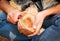 A man in nature carves a kuksa mug from wood. Handmade. Close-up