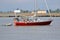 Man Navigating River in Sailboat