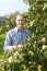 Man near apples trees in garden