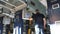 A man near the control panel of a conveyor line for the production of wallpaper, a conveyor belt for the production of