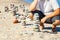 Man near pyramids of balanced stones on beach