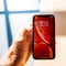 Man new Apple iphone Xr red with liquid retina display