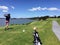 Man with a nice follow through playing golf along the coast of n