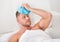 Man nursing a hangover holding an ice pack