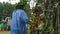 man with oak wreath tries to light a huge bonfire decorated with meadow flowers