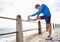 Man, ocean and stretching for fitness with exercise to jog, health and fresh with wellness and body care. Male person