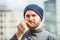 Man offering a french frie close up view - urban background