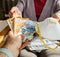 Man offering a stack of money to woman for an FFP2 surgical respirators