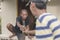 A man offers his drink to his friend. Traditional tagay culture in Filipino men sharing drinks