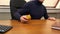 A man in an office plays on a table with a ball