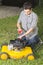 Man oiling yellow lawn mower