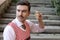 Man with old fashioned elegant look holding wooden spinning top