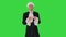 Man in old-fashioned laced frock coat and white wig making a bow looking at camera on a Green Screen, Chroma Key.