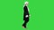 Man in old-fashioned laced frock coat and white wig walking in a mannered way looking at camera on a Green Screen