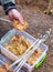 Man one hand holding the meat, other - stringing skewer