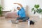 Man during online steaming. Home yoga workout - stretching back.