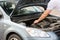 Man opening car bonnet