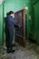 Man opening hermetic metal armored doors with valve - entrance of soviet bomb shelter