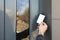 Man opening magnetic door lock with key card, closeup