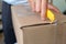 A man opening a postal box with a cutter at his home. Come from United states and use prioprity mail service.