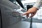 A man opens a car door with a fingerprint. Integrated handle.