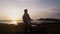 Man opens his arms wide against beautiful gold sunset on beach, expresses sense of freedom, happines