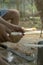 Man opens tropical coconuts at home with home knife