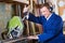 Man operating circular saw in wood workshop