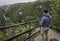 Man is operating drone with a Plitvice waterfalls background