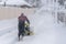 Man operating snow blower to remove snow on driveway. A man cleans the road from the snow. Snowy road. snowy winter
