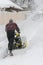 Man operating snow blower to remove snow on driveway. Man using a snowblower. A man cleans snow from sidewalks with