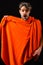 Man with orange towel ready to take shower. Macho attractive nude guy black background. Man bearded tousled hair covered