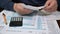 A man organizing individual income tax return form 1040 and receipts. Blurred background. Tax time.Tax concept. Close-up